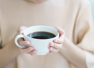 woman holding cup of coffee