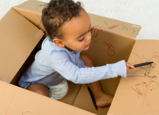 Toddler in Cardboard Box