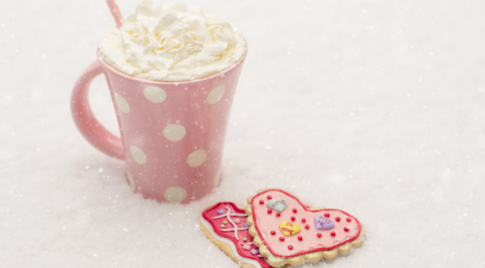 hot chocolate in pink mug with heart cookies