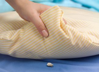 hand lifting pillow, tooth underneath