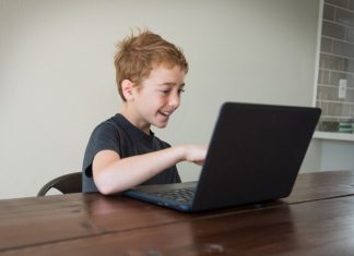 boy doing virtual learning at the kitchen table
