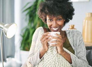 woman smiling and drinking coffee