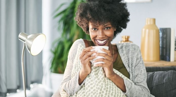 woman smiling and drinking coffee