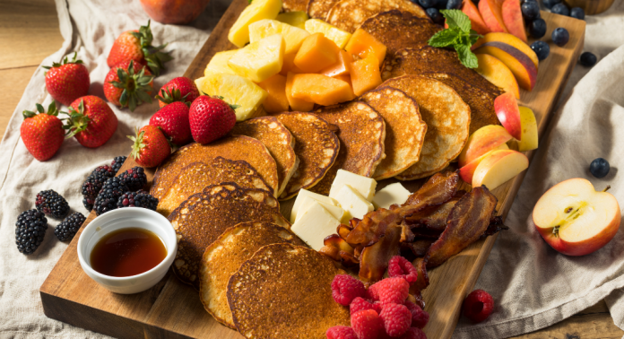 charcuterie board with pancakes, fruit