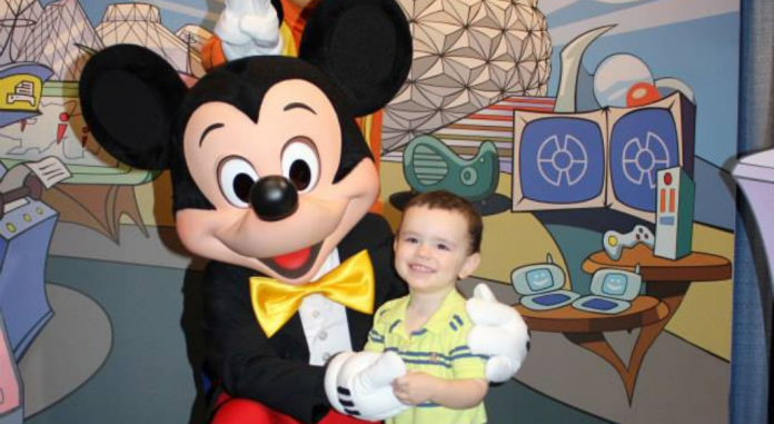 toddler boy with Mickey Mouse at Disney World