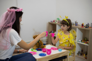 girl in play therapy with tea party