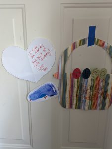 kid's personalized artwork taped to a door