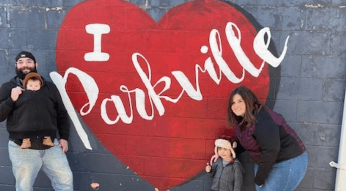 family in front of Parkville Heart mural