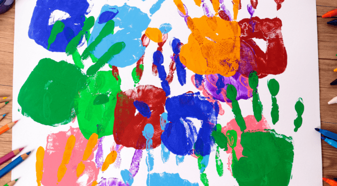 painted kid hands on paper