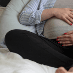 pregnant woman with hands on belly