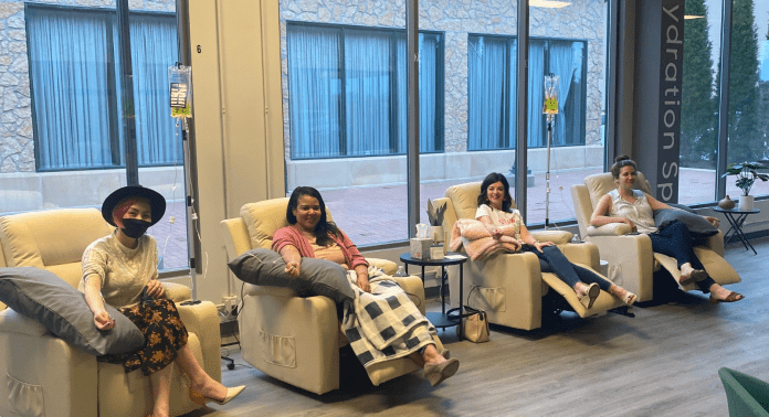 women in chairs at hydration spa