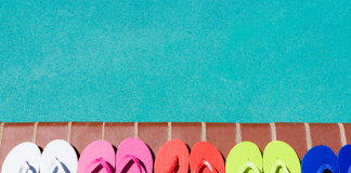 flip flops lined up next to swimming pool