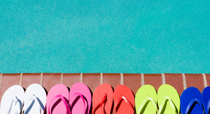 flip flops lined up next to swimming pool