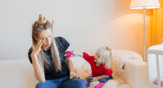 mom with toddler looking depressed