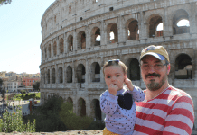 Dad and baby daughter in front of the Roman Colosseum