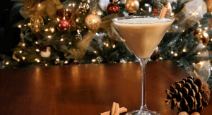 coffee drink in a martini glass against a Christmas tree background for story on holiday coffee drinks.