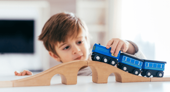 boy playing with toy train