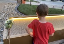 boy looking at victim names on 9/11 Memorial in Overland Park